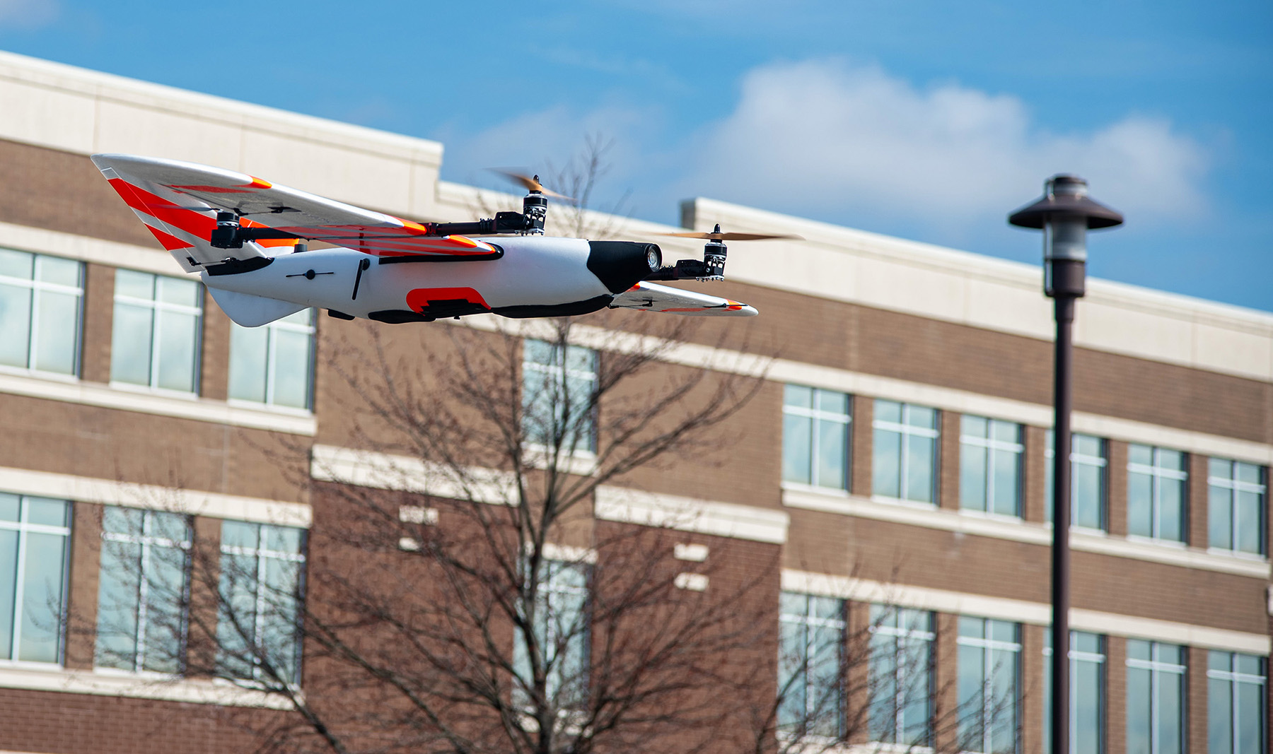 Close-up of a drone flying in front of a building.